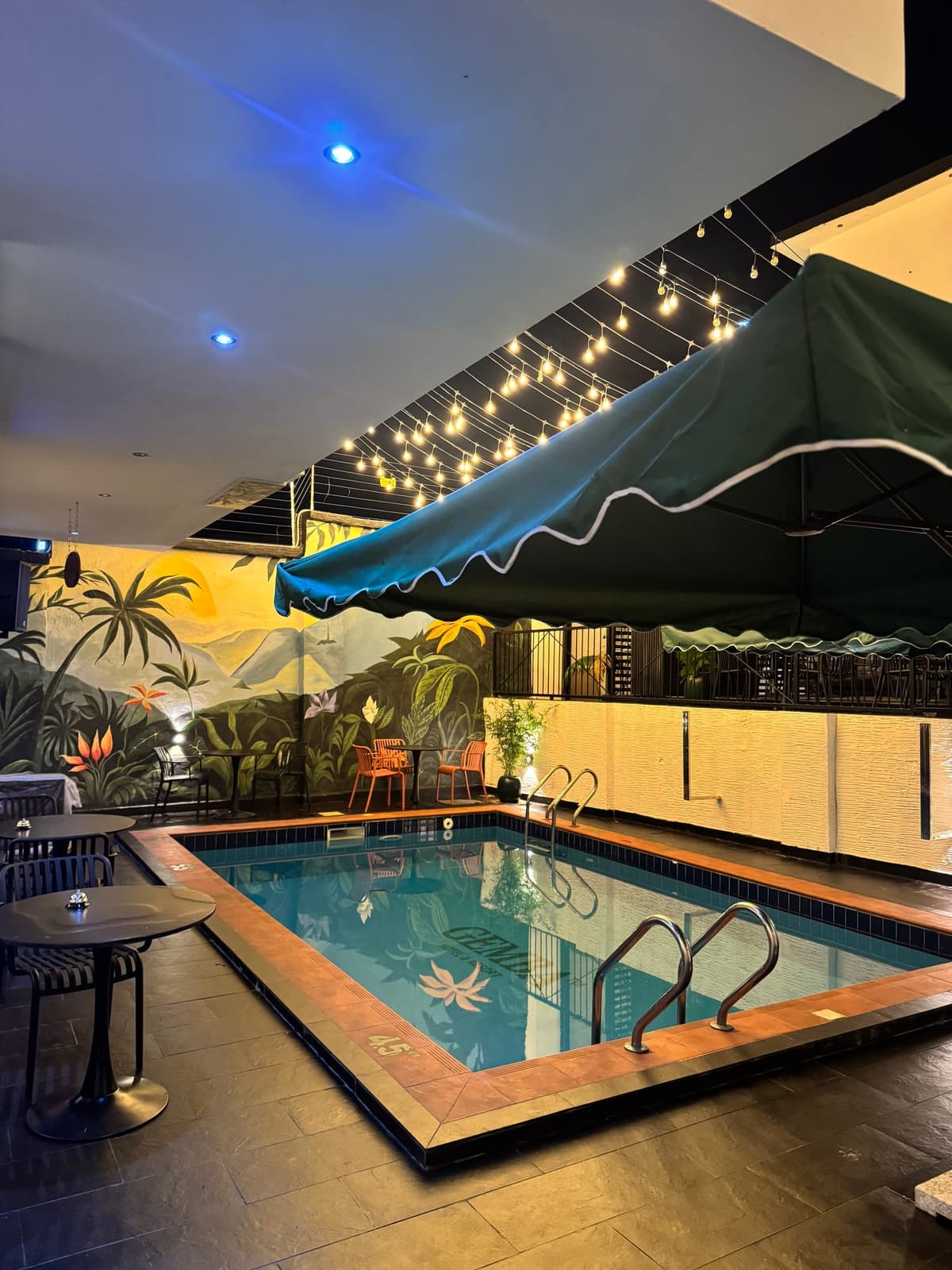Gemba Hotel poolside area with lights and seating