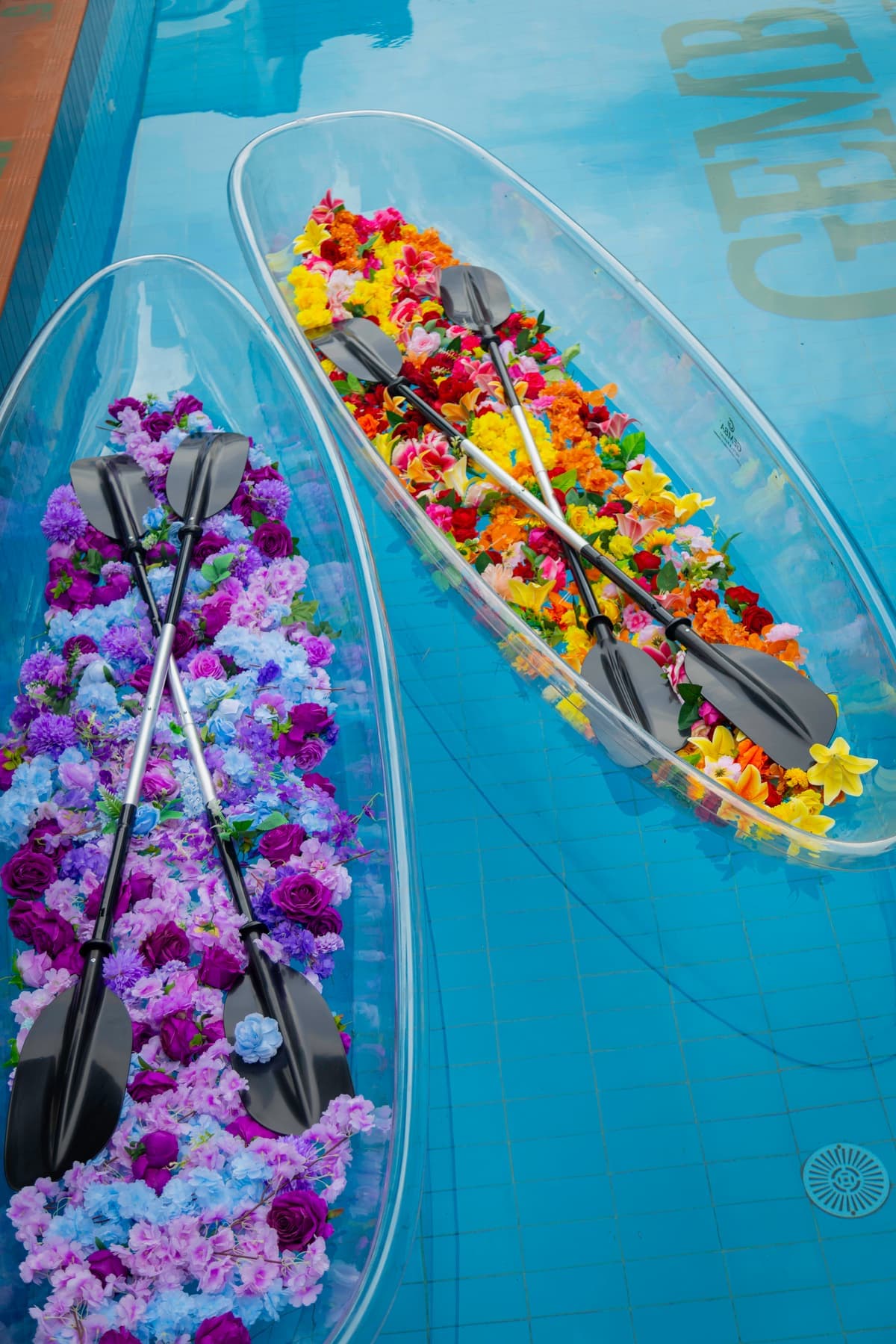 Clear pool boats styled with colourful flowers